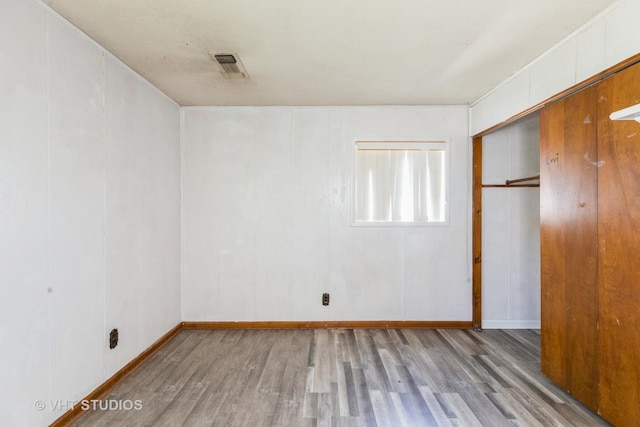 21822 Merrill Ave, Sauk Village, IL 60411 - unfurnished bedroom featuring wood finished floors, a closet, and baseboards