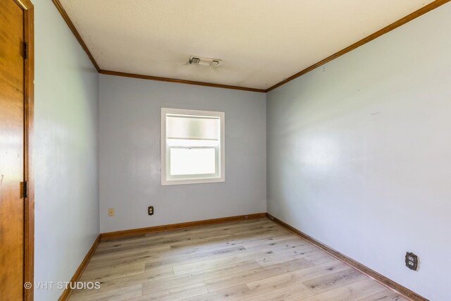 21822 Merrill Ave, Sauk Village, IL 60411 - empty room featuring ornamental molding, light wood-style flooring, and baseboards