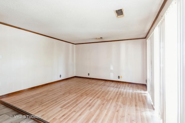 21822 Merrill Ave, Sauk Village, IL 60411 - unfurnished room featuring ornamental molding, light wood-type flooring, and baseboards
