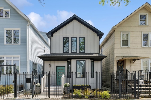 view of front facade with board and batten siding, a fenced front yard, a gate, and a porch