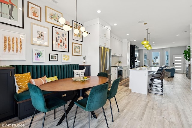 dining room with recessed lighting, light wood-style flooring, breakfast area, and visible vents