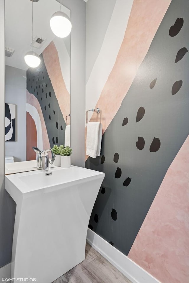 bathroom featuring visible vents and wood finished floors