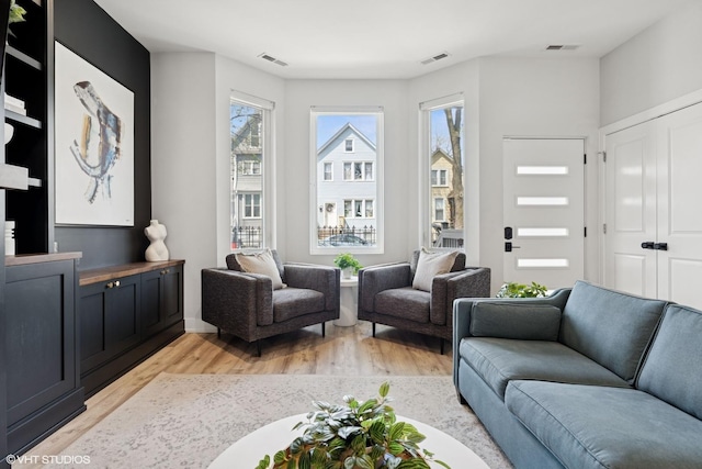 living area featuring visible vents and light wood-type flooring