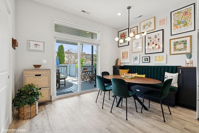 dining space with recessed lighting, light wood finished floors, and visible vents