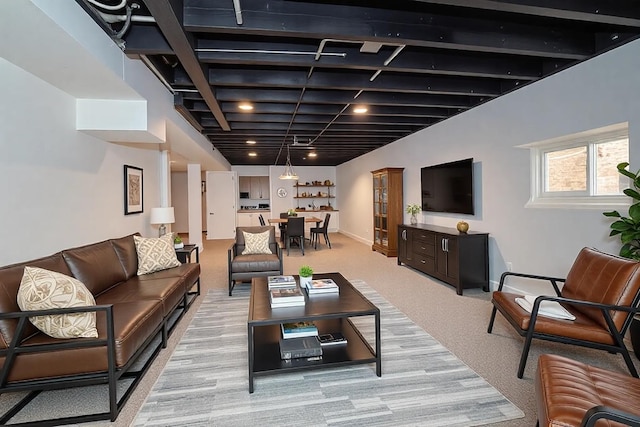 living room featuring light colored carpet and baseboards