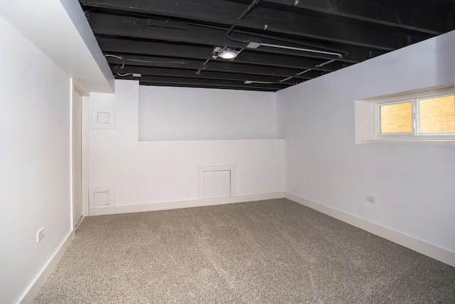 below grade area with baseboards and carpet