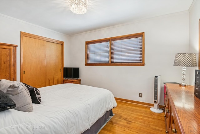 6223 S Rutherford Ave, Chicago, IL 60638 - bedroom featuring light wood-type flooring, ornamental molding, baseboards, and an inviting chandelier