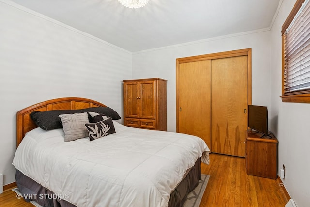 6223 S Rutherford Ave, Chicago, IL 60638 - bedroom with crown molding, baseboards, a closet, and wood finished floors
