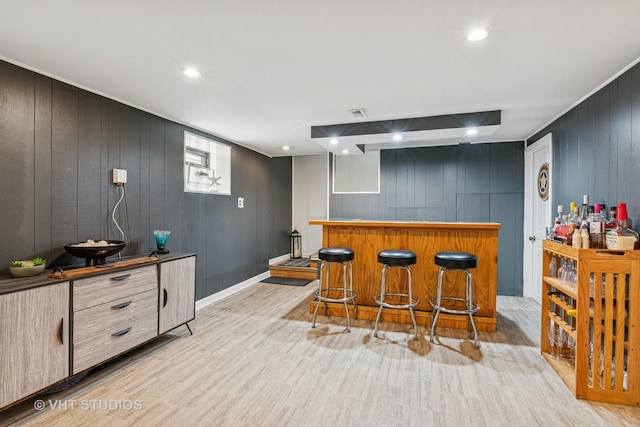 6223 S Rutherford Ave, Chicago, IL 60638 - bar featuring recessed lighting, wood walls, a bar, and light wood finished floors