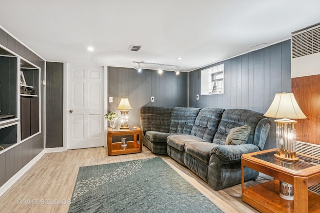 6223 S Rutherford Ave, Chicago, IL 60638 - living area featuring wooden walls, visible vents, and wood finished floors