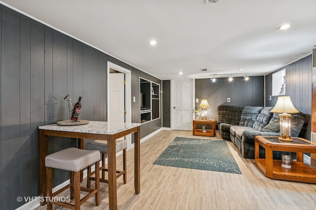 6223 S Rutherford Ave, Chicago, IL 60638 - living room featuring crown molding, built in features, light wood finished floors, wooden walls, and recessed lighting