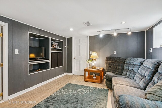 6223 S Rutherford Ave, Chicago, IL 60638 - living area with visible vents, rail lighting, wood finished floors, baseboards, and wooden walls