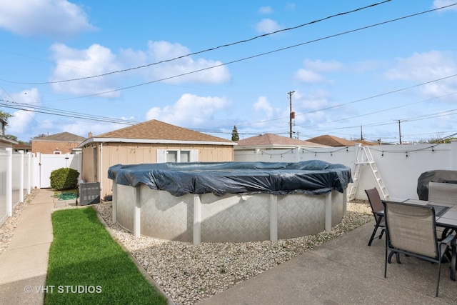 6223 S Rutherford Ave, Chicago, IL 60638 - view of swimming pool featuring a fenced backyard, a fenced in pool, outdoor dining area, and central air condition unit
