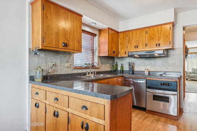 6223 S Rutherford Ave, Chicago, IL 60638 - kitchen featuring a healthy amount of sunlight, appliances with stainless steel finishes, dark countertops, a sink, and under cabinet range hood