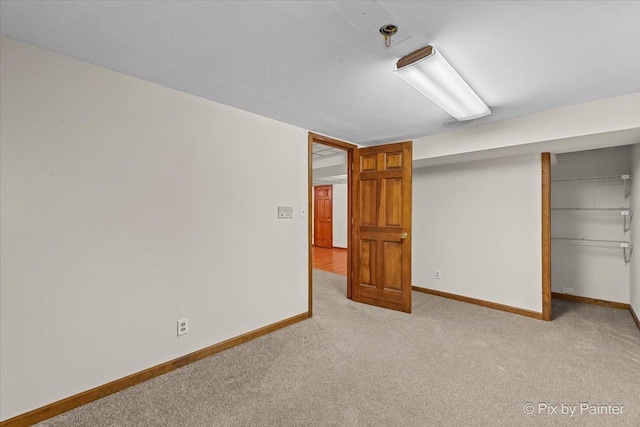 interior space featuring baseboards, carpet flooring, and a closet