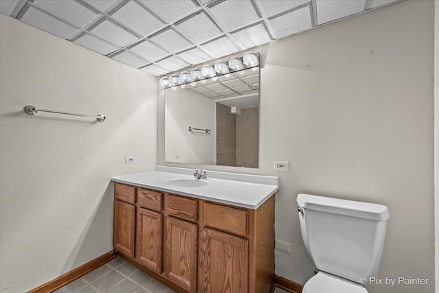 bathroom with vanity, baseboards, and toilet