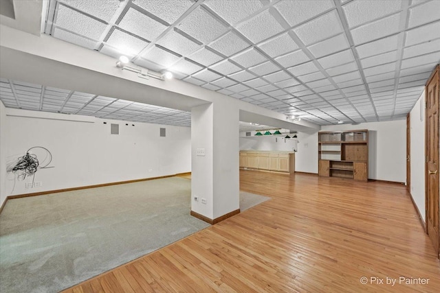 finished below grade area with baseboards and hardwood / wood-style floors