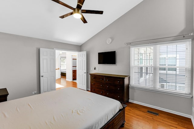 bedroom with visible vents, baseboards, high vaulted ceiling, a ceiling fan, and light wood finished floors