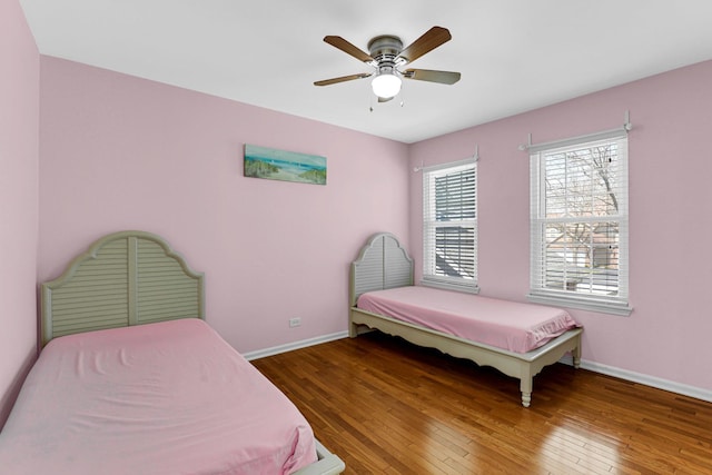 bedroom with baseboards, ceiling fan, and hardwood / wood-style flooring