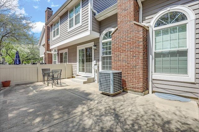 view of patio with fence and central AC unit