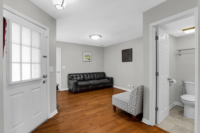 entryway with baseboards and wood finished floors