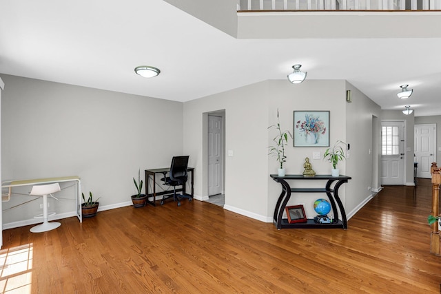 interior space featuring baseboards and wood finished floors