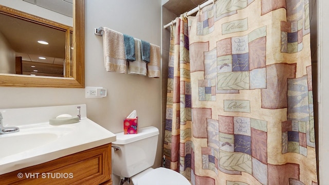 bathroom with recessed lighting, vanity, toilet, and curtained shower