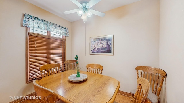 dining room with baseboards, ceiling fan, and wood finished floors