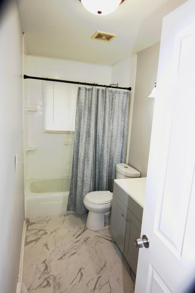 full bath featuring visible vents, shower / bath combo with shower curtain, marble finish floor, vanity, and toilet