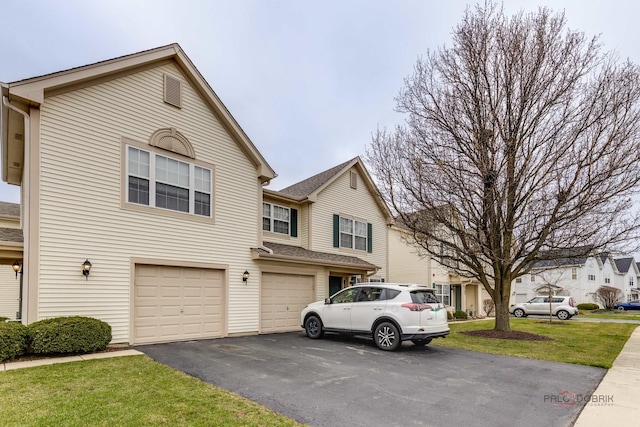 2509 Dickens Dr, Aurora, IL 60503 - multi unit property with asphalt driveway, a garage, and a front yard