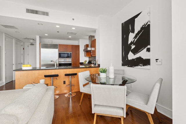 dining room with recessed lighting, visible vents, and wood finished floors