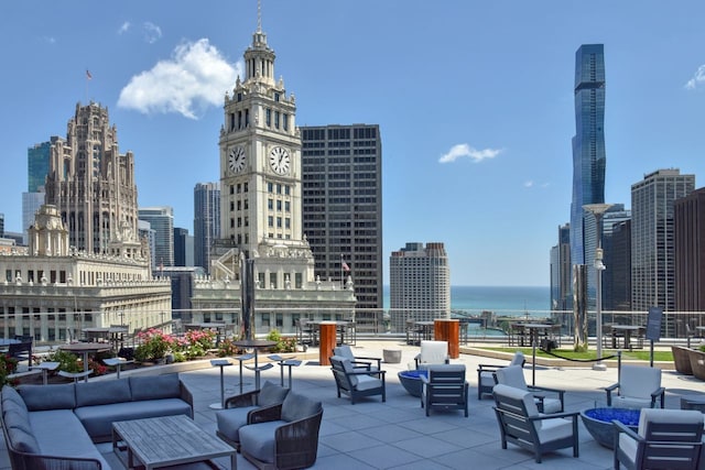 view of patio / terrace with an outdoor hangout area, a view of city, and a water view