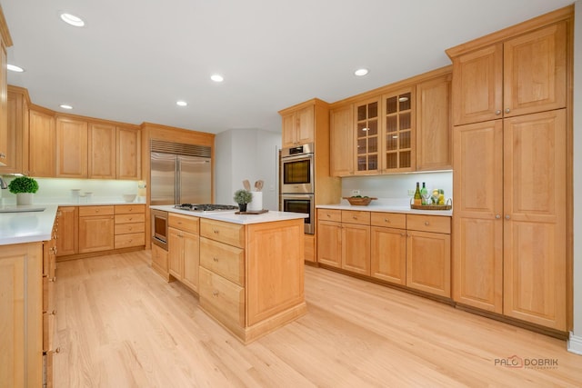 590 Academy Woods Dr, Lake Forest, IL 60045 - kitchen featuring stainless steel appliances, light wood-style flooring, light brown cabinets, light countertops, and recessed lighting
