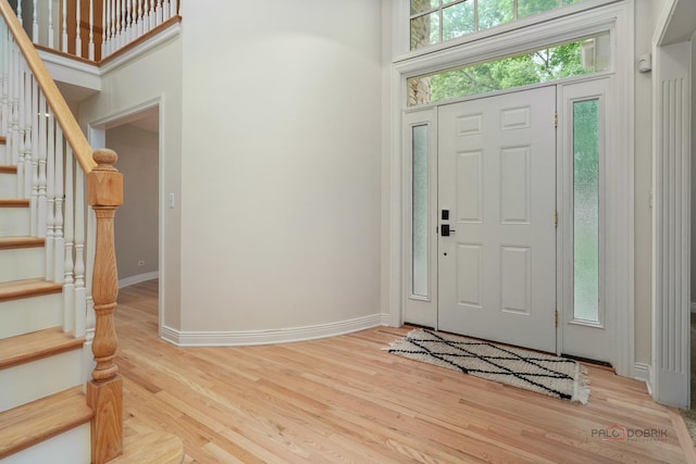 590 Academy Woods Dr, Lake Forest, IL 60045 - entryway featuring stairway and light wood-style flooring