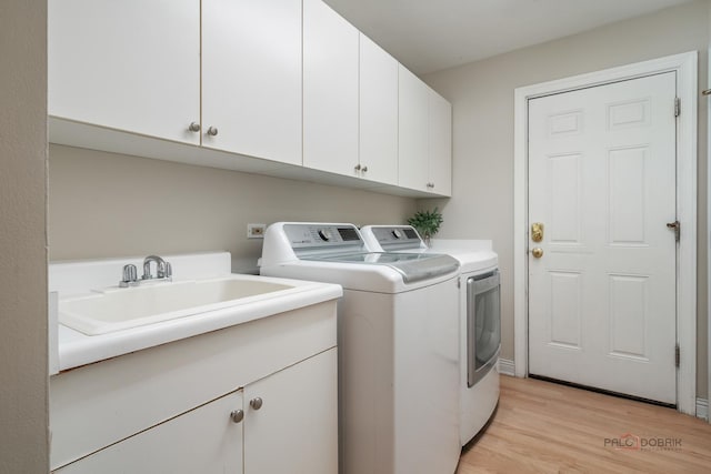590 Academy Woods Dr, Lake Forest, IL 60045 - washroom featuring washing machine and clothes dryer, cabinet space, and light wood-style floors