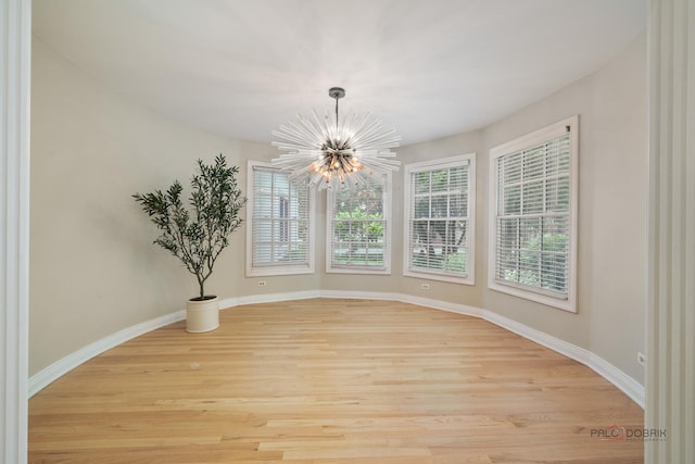 590 Academy Woods Dr, Lake Forest, IL 60045 - unfurnished dining area featuring a chandelier, healthy amount of natural light, and light wood finished floors