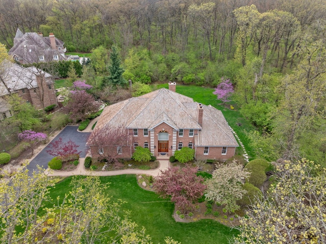 view of subject property with a heavily wooded area