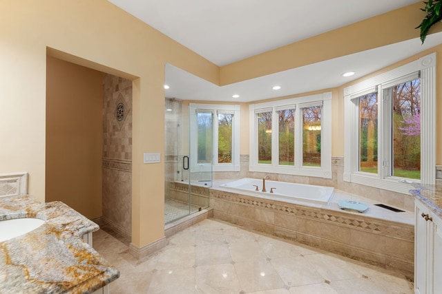 full bath with vanity, a shower stall, a bath, and recessed lighting