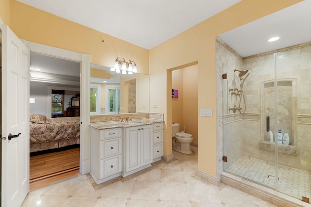 ensuite bathroom featuring a stall shower, toilet, vanity, and tile patterned flooring