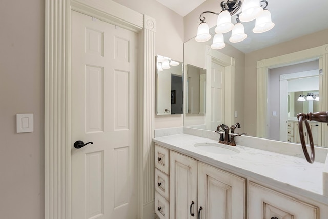 bathroom featuring a chandelier and vanity
