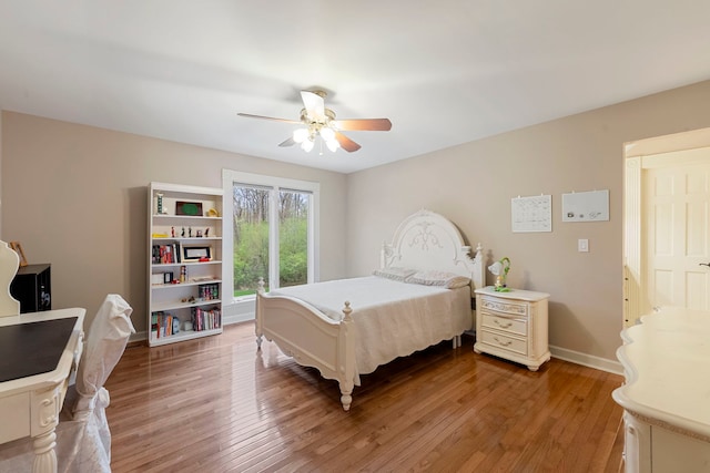 bedroom featuring light wood finished floors, baseboards, and ceiling fan