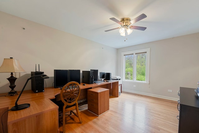 office area featuring light wood-type flooring, ceiling fan, and baseboards