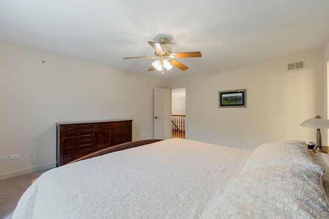 carpeted bedroom with ceiling fan and baseboards