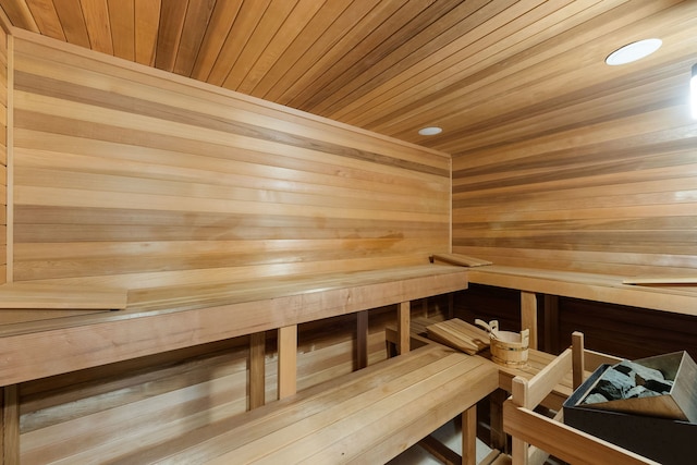 relaxing sauna / steam room featuring wooden ceiling and recessed lighting