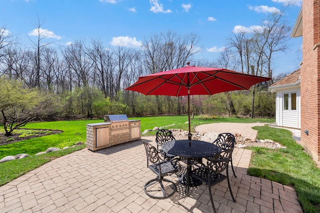 view of patio featuring exterior kitchen, outdoor dining space, and grilling area
