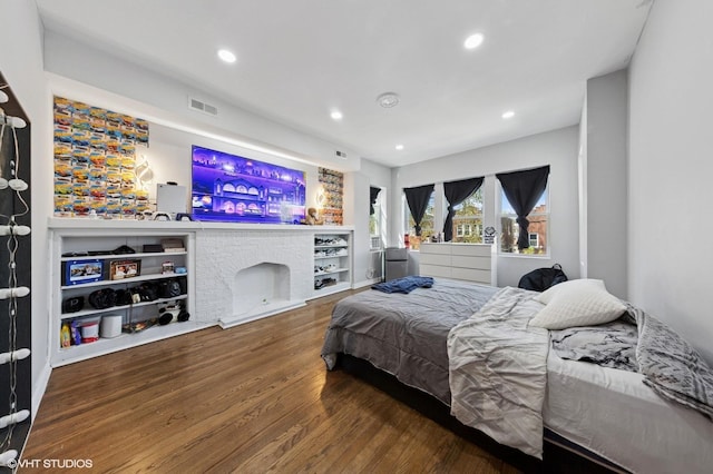 bedroom with recessed lighting, visible vents, and wood finished floors