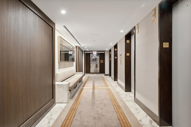 corridor featuring recessed lighting, elevator, and marble finish floor