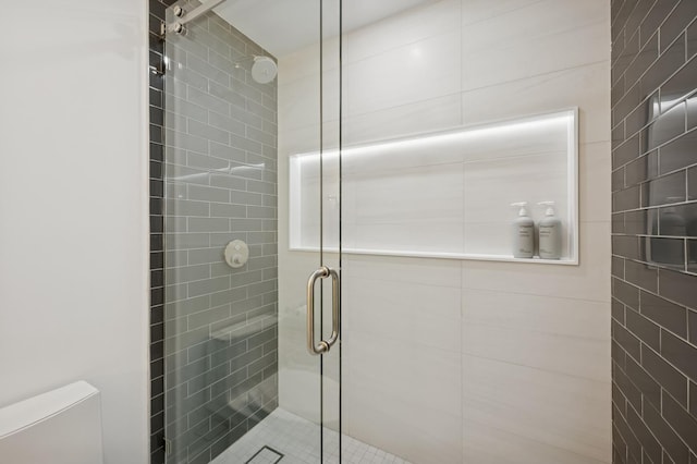 full bathroom with toilet and a stall shower