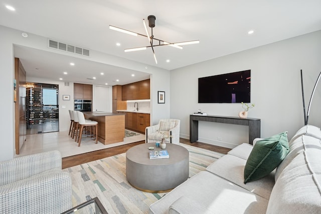 living room featuring recessed lighting, baseboards, and visible vents