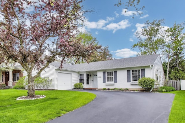 ranch-style house with an attached garage, asphalt driveway, brick siding, and a shingled roof